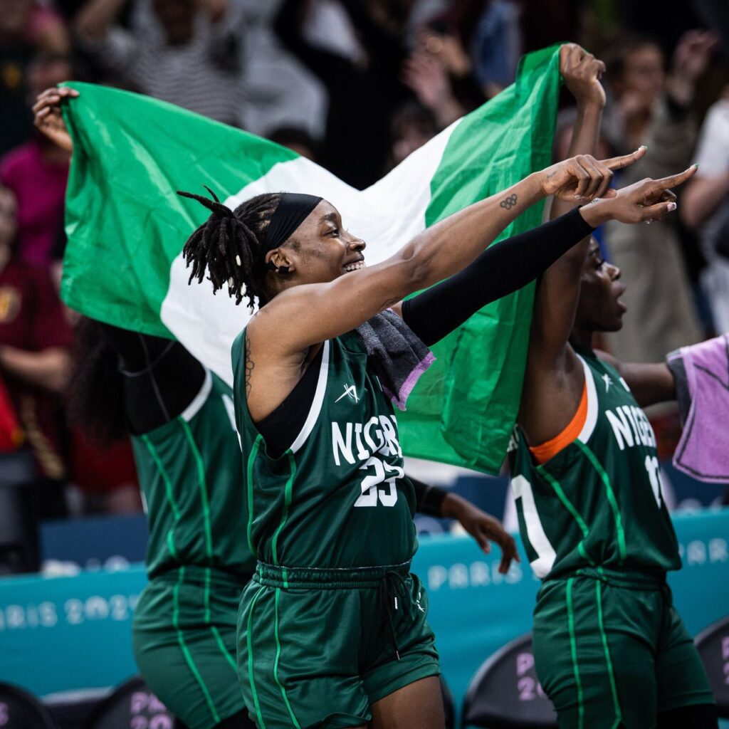 Nigeria women's basketball team wave the flag after their historic achievement at the Paris 2024 Olympics